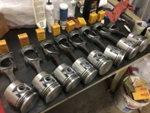 Straight-eight Packard engine rebuild pistons ready for install